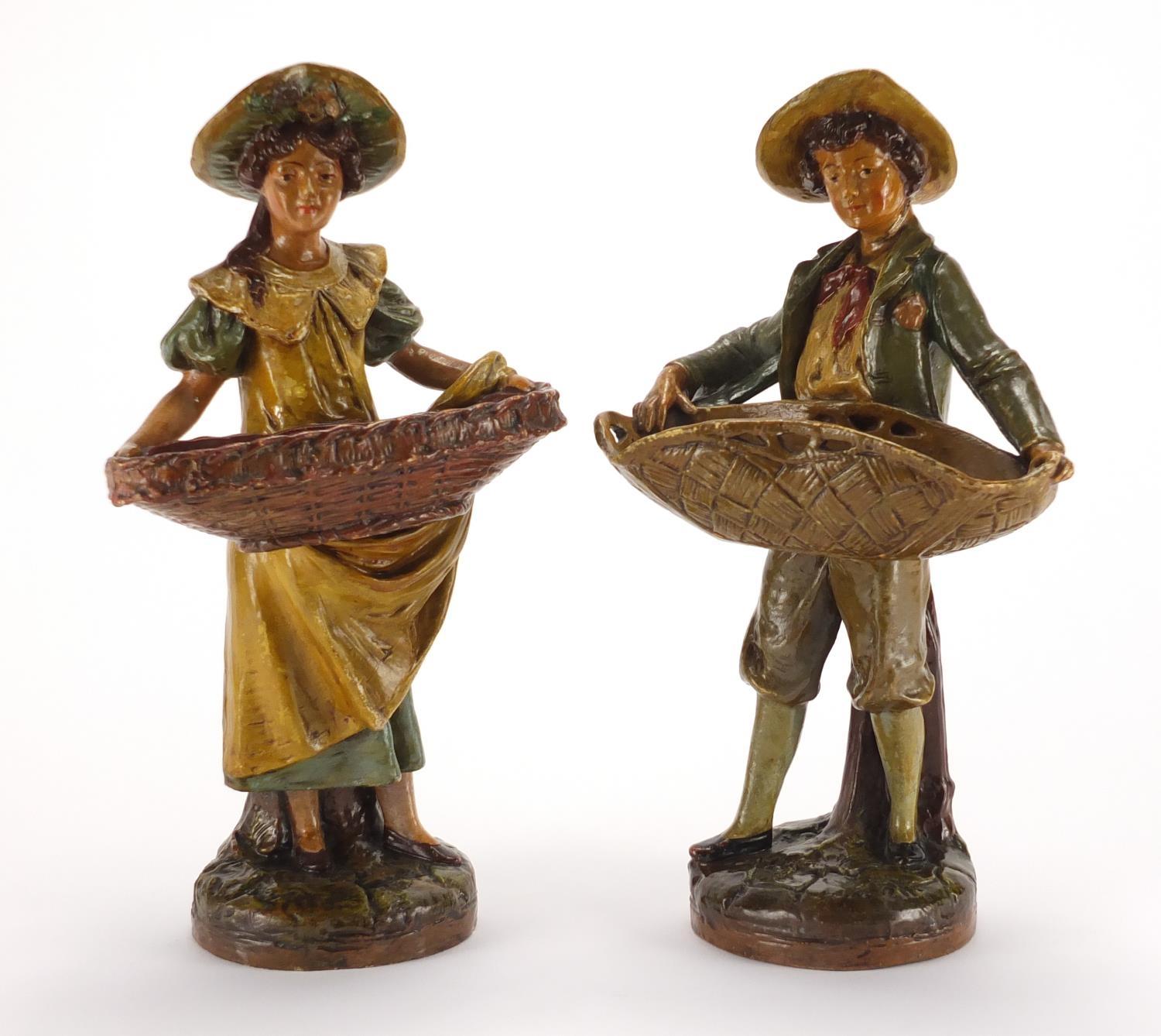 Pair of 19th century hand painted terracotta figural sweet meat dishes, impressed numbers to the