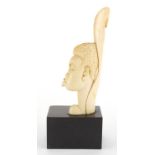 Early 20th century African ivory carving of a female, raised on rectangular ebonised block base,
