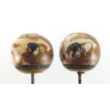Pair of Japanese Satsuma pottery hat pins, hand painted with geisha's, each 28.5cm in length :For