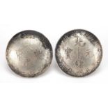 Two Chinese silver coloured metal coin design buttons, each 3.9cm in diameter, approximate weight