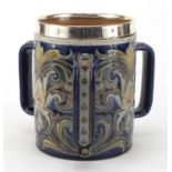 Art Nouveau Doulton Lambeth tyg with silver mounted rim, hand painted and incised with stylised