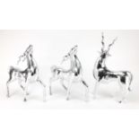 Three silvered models of standing gazelles, the largest 44cm high : For Further Condition Reports