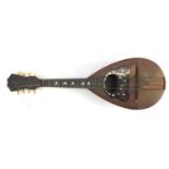 19th century rosewood mandolin with inlaid tortoiseshell guard and ivory pegs, bearing a Umberto
