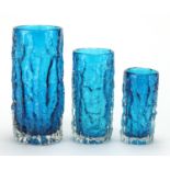 Graduated set of three Whitefriars kingfisher blue cylindrical bark vases, designed by Geoffrey