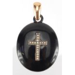 Victorian black Bakelite mourning locket with unmarked gold and seed pearl crucifix inlay, 6.5cm