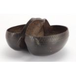 Tribal interest Coco De Mer nut basket, the rim carved with a chevron design, 27cm in length :For