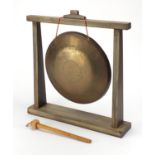 Large Chinese brass dinner gong, with archaic style wood stand, the gong engraved with dragons and