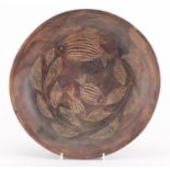 Tribal interest pottery shallow bowl, incised with stylised fish and leaves, 28.5cm in diameter :For