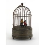 Early 20th century clockwork automaton bird cage, with two feathered birds, 24cm high :For Further