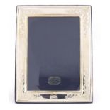 Rectangular silver easel photo frame, with embossed decoration, by Carrs, 22.5cm x 18cm :For Further