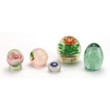 Four Victorian glass paperweights and an Orient & Flume iridescent peach design example with paper