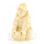 Dieppe carved ivory figure of a young girl washing, incised numbers to the base, 6.5cm high :For
