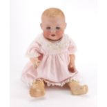 Armand Marseille bisque headed doll, with open close eyes and jointed limbs in traditional dress,