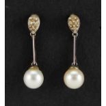 Pair of 9ct white gold pearl and diamond drop earrings, 2.2cm in length, approximate weight 1.5g :