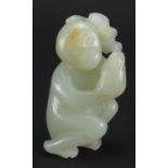 Chinese pale green and russet jade carving of a monkey holding a nut, 6cm high :For Further