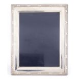 Rectangular silver easel photo frame, with stylised border, by Carrs, 26cm x 21cm :For Further