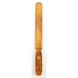 Chinese Canton ivory page turner, the handle carved with figures, 19cm in length :For Further