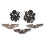 Five American Military World War II USAAF badges comprising two officer's cap badges, pilot wings,