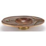 Sam Fanaroff oval copper and brass dish having an applied flower design, set with a green