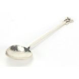 Arts & Crafts hammered silver spoon with fig shaped bowl and stylised floral finial, by A E Jones,