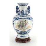 Chinese blue and white porcelain vase, with twin handles raised on hardwood stand, the two central