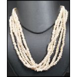 An early 20th century silver white metal and baroque pearl 5 strand ladies necklace. The silver