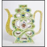 An early 20th century Chinese Famille Verte Shou form puzzle teapot, decorated to both sides on a