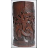 A 19th century Oriental Chinese carved bamboo brush / pen pot of large form having carved images