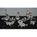 A group of Swarovski miniature animals to include dolphin , dinosaur , lizards , frogs seal etc.