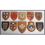 A collection of 20th century Armorial shields / Coat of Arms to include Caernarvon, Glamorgan,