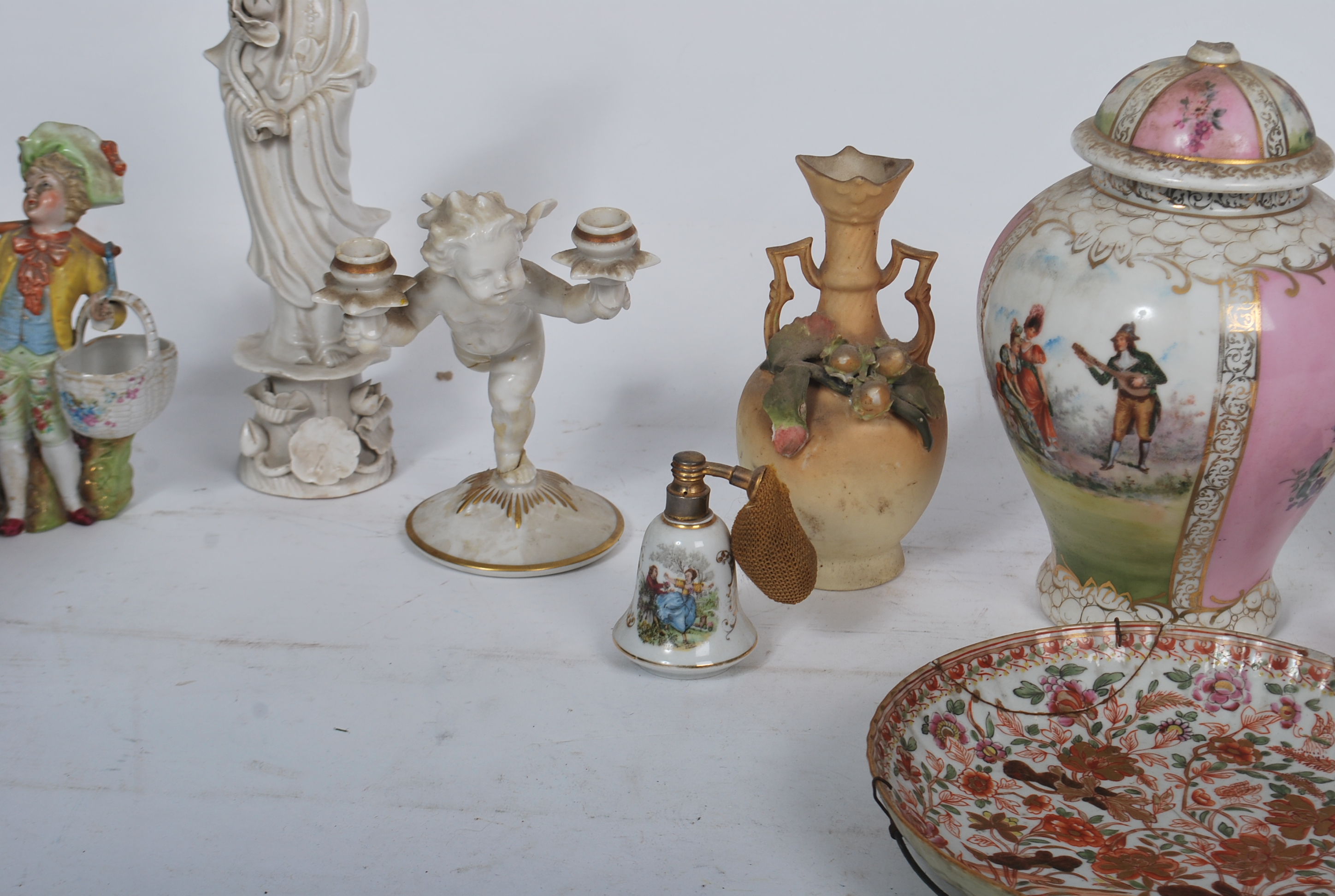 A Chinese blanc de chine figurine of a deity together with a German biscuit glaze cherub figurine - Image 5 of 9