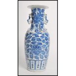 A 19th century Chinese ceramic vase having twin dragon handles and Fu dogs to the neck. The vase