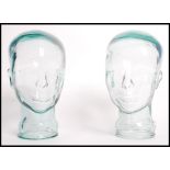 A pair of 20th century moulded pressed glass phrenology type heads - shop display stand /