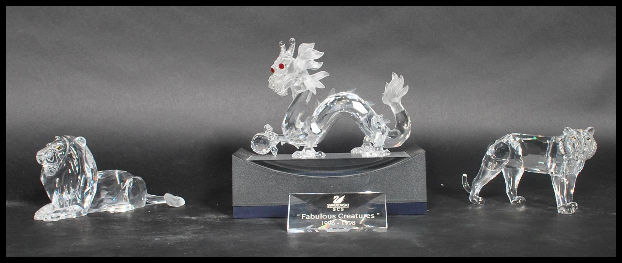 Three Swarovski cut glass figures annual edition 1997, Chinese dragon with red crystal eyes, '