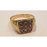 A gents vintage 9ct yellow gold ring having pave set stones with ribbed shoulders. Total weight 6.
