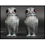 A pair of Continental silver novelty condiments / salt and pepper shakers in the form of owls having