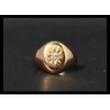 A Victorian hallmarked 18ct gold and diamond signet ring having a single diamond set in a star cut