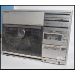A retro 1980's upright Sharp VZ-3500 record player stereo system having smoked acryllic record