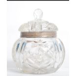 A silver hallmarked collared cut glass jam condiment with lid having opening for spoon. Hallmarked