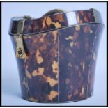 An unusual faux tortoiseshell tea caddy in the form of a hat box. Measures 15cms high.