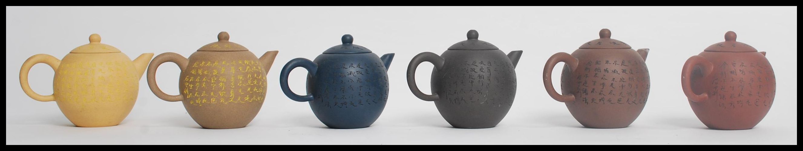 A group of six Chinese Yi Zing terracotta teapots of bulbous form having calligraphy decoration. - Image 3 of 6