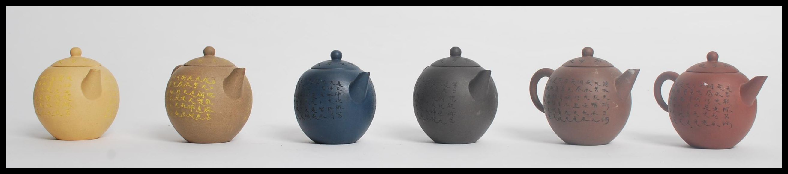 A group of six Chinese Yi Zing terracotta teapots of bulbous form having calligraphy decoration. - Image 4 of 6