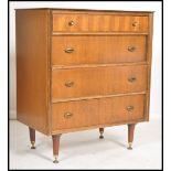 A vintage 20th century teak veneered chest of drawers raised on tapering. The bank of four drawers
