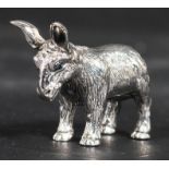 A sterling silver miniature novelty figurine of a donkey with faceted bead eyes. Weighs 19.2