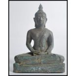 A 19th century Oriental Chinese bronze figurine of a Buddha in the seated lotus position raised on a