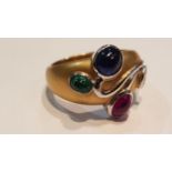 An 18ct yellow gold ruby, emerald, Sapphire and diamond ring in the Art Nouveau manner having