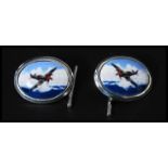 A pair of sterling silver cufflinks having enamel pictorials of spitfires in flight. Weighs 9.1