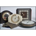 A group of vintage mid 20th century clock to include a wooden cased Art Deco square clock, two