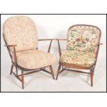 A matched pair of 20th century Ercol beech wood windsor pattern armchairs. Both raised on turned