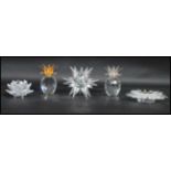 A group of Swarovski candlestick to include a sunburst example, star, lotus flower and two pineapple